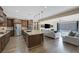Spacious kitchen features wooden cabinets, stainless appliances, and a large center island with granite countertops at 6021 Vista Clara St, Las Vegas, NV 89148