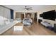 Open-concept living area featuring wood floors, neutral tones, and seamless access to the kitchen at 6021 Vista Clara St, Las Vegas, NV 89148