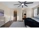 Spacious bedroom with hardwood flooring and a ceiling fan with an entrance to the kitchen at 6021 Vista Clara St, Las Vegas, NV 89148