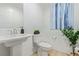 Clean and bright half-bathroom with modern fixtures, a pedestal sink, and stylish decor at 6208 Rathbone St, Las Vegas, NV 89166