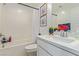 Bathroom features a shower and tub, single vanity, and modern finishes at 6208 Rathbone St, Las Vegas, NV 89166