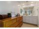Bathroom features a wood dresser, double vanity, and large mirrors at 6208 Rathbone St, Las Vegas, NV 89166