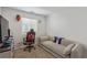 Neutral-toned bedroom showcasing cozy couch, window, gamer chair, and carpet at 6208 Rathbone St, Las Vegas, NV 89166