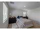 Comfortable bedroom with a patterned bedspread, carpet flooring and natural light at 6208 Rathbone St, Las Vegas, NV 89166