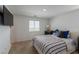 Bright bedroom features a striped bedspread, natural light, and neutral decor at 6208 Rathbone St, Las Vegas, NV 89166