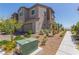 View of home with a two-car garage, desert landscaping, and paved driveway and sidewalk at 6208 Rathbone St, Las Vegas, NV 89166