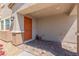 Front porch with decorative stone accents and an orange front door at 6208 Rathbone St, Las Vegas, NV 89166