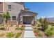 Charming two-story townhome with landscaped front yard, stone walkway, and covered porch at 6208 Rathbone St, Las Vegas, NV 89166
