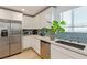 Bright kitchen featuring white cabinets, stainless steel appliances, and a stylish backsplash at 6208 Rathbone St, Las Vegas, NV 89166