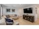Inviting living room with a sectional sofa, entertainment center, and stylish decor at 6208 Rathbone St, Las Vegas, NV 89166