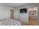 Bright main bedroom with a tv, ensuite bathroom, and neutral decor at 6208 Rathbone St, Las Vegas, NV 89166