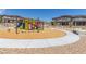 Community playground with slides, climbing features, and seating area at 6208 Rathbone St, Las Vegas, NV 89166
