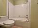Clean bathroom featuring tiled walls, a bathtub, and a toilet at 6250 W Flamingo Rd # 135, Las Vegas, NV 89103