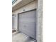 One-car garage with traditional panel door and unit number above at 6250 W Flamingo Rd # 135, Las Vegas, NV 89103