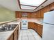 Well-lit kitchen with ample counter space, white appliances, and wood cabinetry at 6250 W Flamingo Rd # 135, Las Vegas, NV 89103