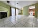 Spacious living room featuring tile floors, a fireplace, and access to the kitchen space at 6250 W Flamingo Rd # 135, Las Vegas, NV 89103