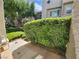 A small outdoor patio features a chair next to a decorative bush at 6250 W Flamingo Rd # 135, Las Vegas, NV 89103