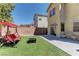 Landscaped backyard featuring artificial turf, perfect for outdoor entertaining and relaxation at 6457 Lovett Canyon St, Las Vegas, NV 89148