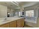 This bathroom has a large mirror, double sinks, and a separate tub and shower at 6457 Lovett Canyon St, Las Vegas, NV 89148