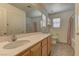 Bright bathroom with a large mirror, neutral tones, and a combined tub and shower at 6457 Lovett Canyon St, Las Vegas, NV 89148