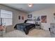 This bedroom features a bed, dark bedding, natural light, and unique wall art at 6457 Lovett Canyon St, Las Vegas, NV 89148