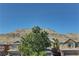 A tree is viewed, along with the community and mountains at 6457 Lovett Canyon St, Las Vegas, NV 89148