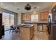 Bright kitchen with stainless steel appliances, island, and a dining area with backyard views at 6457 Lovett Canyon St, Las Vegas, NV 89148