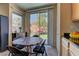 Cozy eat-in kitchen with a dining table next to a large window overlooking the backyard at 6457 Lovett Canyon St, Las Vegas, NV 89148