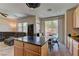 Open kitchen/living space with a center island, casual seating, and seamless flow to the living area at 6457 Lovett Canyon St, Las Vegas, NV 89148