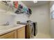 Functional laundry room featuring a utility sink and modern washer and dryer set at 6457 Lovett Canyon St, Las Vegas, NV 89148
