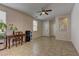 Inviting living room with neutral colors, tile flooring, and a ceiling fan for added comfort at 6457 Lovett Canyon St, Las Vegas, NV 89148