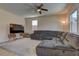 Cozy living room showcasing a comfortable gray sectional and a large flat-screen television at 6457 Lovett Canyon St, Las Vegas, NV 89148