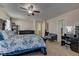 This main bedroom includes furniture, a ceiling fan, a sitting area, and natural light at 6457 Lovett Canyon St, Las Vegas, NV 89148