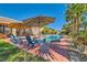 Lush backyard with a beautiful pool, patio, and mature landscaping, perfect for outdoor living at 6527 Lokai Ave, Las Vegas, NV 89130
