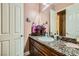 Well-lit bathroom featuring granite counters, modern fixtures, and decorative accents, offering a blend of style and functionality at 6527 Lokai Ave, Las Vegas, NV 89130