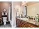 Stylish bathroom with granite countertop, decorative wall tiles, and updated fixtures with shower and toilet at 6527 Lokai Ave, Las Vegas, NV 89130