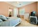 Cozy bedroom featuring soft, neutral tones, carpet flooring, and bright window with plantation shutters at 6527 Lokai Ave, Las Vegas, NV 89130