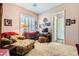 Inviting bedroom featuring a daybed, cozy chair, desk, and plantation shutters for ample natural light at 6527 Lokai Ave, Las Vegas, NV 89130