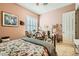 Serene bedroom with floral bedding, plush carpet, and elegant decor with a view of plantation shutters at 6527 Lokai Ave, Las Vegas, NV 89130