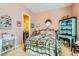Comfortable bedroom with inviting floral bedspread, decorative hutch and mirrored vanity at 6527 Lokai Ave, Las Vegas, NV 89130