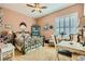 Charming bedroom with a wrought iron bed frame, decorative mirror, and light-filled window with shutters at 6527 Lokai Ave, Las Vegas, NV 89130