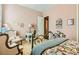 Cozy bedroom with floral accents, comfortable seating, and an open door to the bathroom, filled with charm at 6527 Lokai Ave, Las Vegas, NV 89130