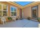 Charming front porch with a welcome sign, outdoor seating, and beautiful potted plants, creating a warm entrance at 6527 Lokai Ave, Las Vegas, NV 89130