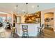 Open kitchen featuring a breakfast bar, granite countertops, and dark wood cabinetry at 6527 Lokai Ave, Las Vegas, NV 89130
