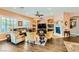 Cozy living room featuring built-in shelving, a fireplace, and large windows with plantation shutters at 6527 Lokai Ave, Las Vegas, NV 89130