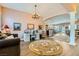 Elegant living room featuring hardwood floors, sophisticated decor, and abundant natural light flowing into the open kitchen at 6527 Lokai Ave, Las Vegas, NV 89130