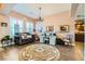 Elegant living room featuring hardwood floors, sophisticated decor, and abundant natural light at 6527 Lokai Ave, Las Vegas, NV 89130