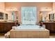 Main bathroom showcasing soaking tub between dual vanities with granite counters at 6527 Lokai Ave, Las Vegas, NV 89130