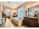 Bright primary bathroom with a soaking tub, dark wood vanities, and linen closet at 6527 Lokai Ave, Las Vegas, NV 89130