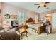 Comfortable main bedroom with a ceiling fan, cozy chair, and shuttered windows at 6527 Lokai Ave, Las Vegas, NV 89130